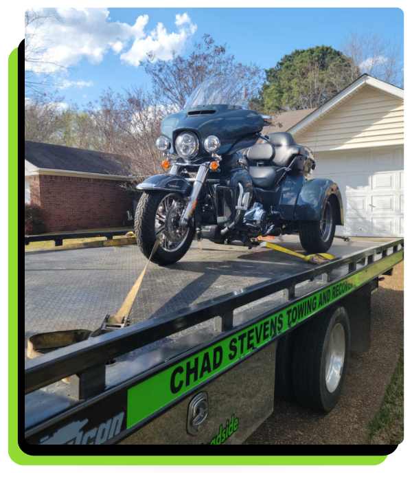 flatbed tow truck holding a motorcycle